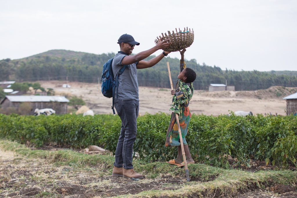 Farmforce rep, Rodney, playing in the field with a young boy.
